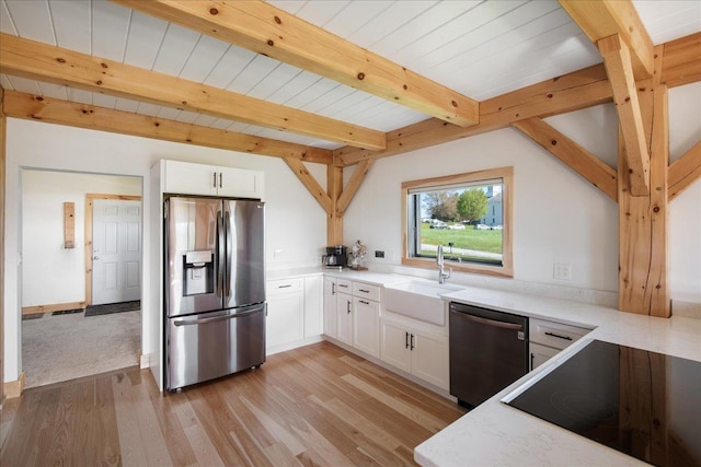 64 Atkins Farm Rd, Ferrisburgh, VT 05456 - kitchen with stainless steel fridge, dishwashing machine, a sink, black electric stovetop, and white cabinets