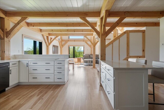 64 Atkins Farm Rd, Ferrisburgh, VT 05456 - kitchen featuring white cabinets, a kitchen bar, light countertops, light wood finished floors, and wooden ceiling