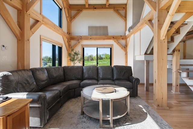 64 Atkins Farm Rd, Ferrisburgh, VT 05456 - living area featuring high vaulted ceiling, light wood-type flooring, and stairway