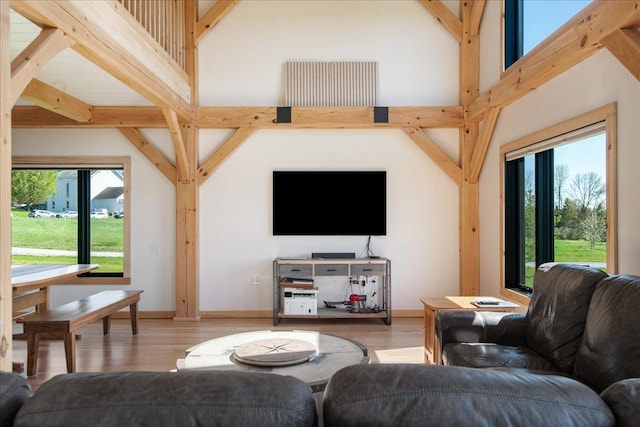 64 Atkins Farm Rd, Ferrisburgh, VT 05456 - living area with wood finished floors, beam ceiling, and baseboards