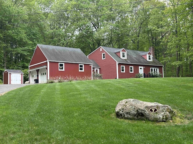7 Juniper Ridge Rd, Exeter, NH 03833 - view of front of home with a detached garage, a chimney, and a front yard
