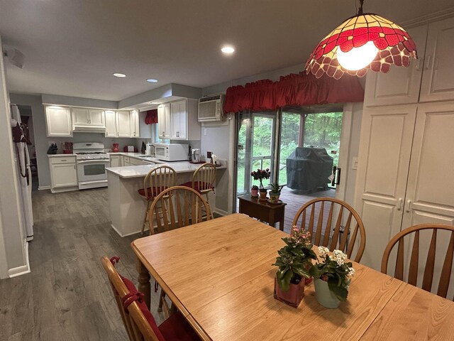 7 Juniper Ridge Rd, Exeter, NH 03833 - dining area featuring dark wood-style floors, recessed lighting, baseboards, and a wall unit AC