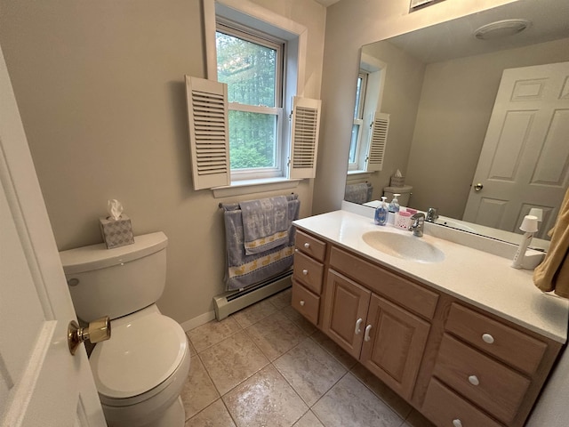 7 Juniper Ridge Rd, Exeter, NH 03833 - bathroom featuring a baseboard radiator, toilet, vanity, tile patterned flooring, and baseboards