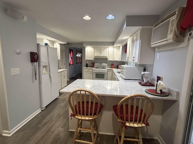 7 Juniper Ridge Rd, Exeter, NH 03833 - kitchen featuring white appliances, under cabinet range hood, baseboards, a peninsula, and dark wood-type flooring