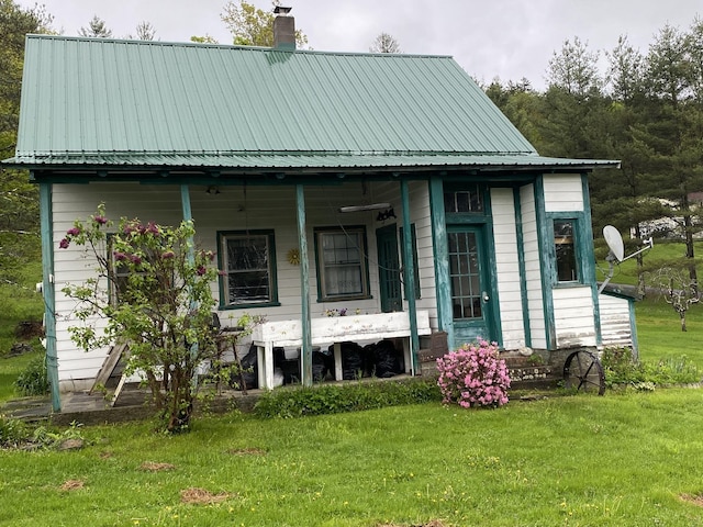 178 Parsons Rd, Wilmington, VT 05363 - view of front of house with a chimney, a porch, a front yard, and metal roof