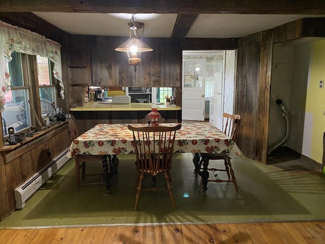 178 Parsons Rd, Wilmington, VT 05363 - dining room featuring baseboard heating, wood walls, hardwood / wood-style floors, and beam ceiling