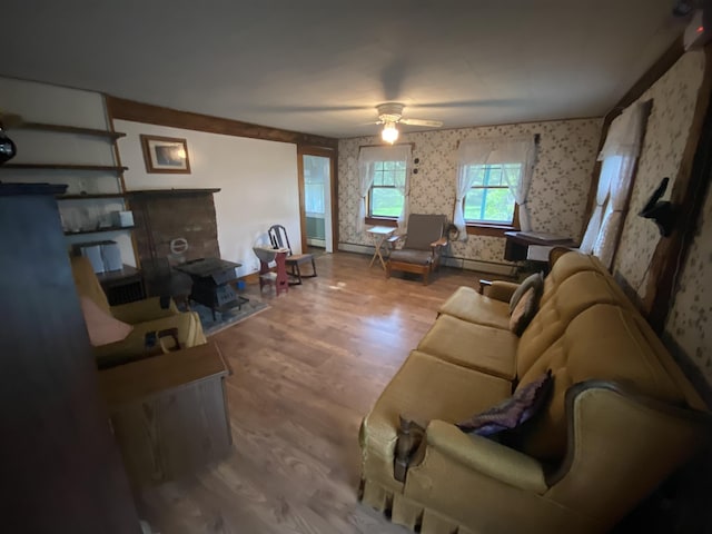 178 Parsons Rd, Wilmington, VT 05363 - living room with wallpapered walls, ceiling fan, wood finished floors, and a baseboard heating unit