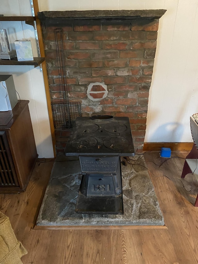 178 Parsons Rd, Wilmington, VT 05363 - detailed view of a wood stove, wood finished floors, and baseboards