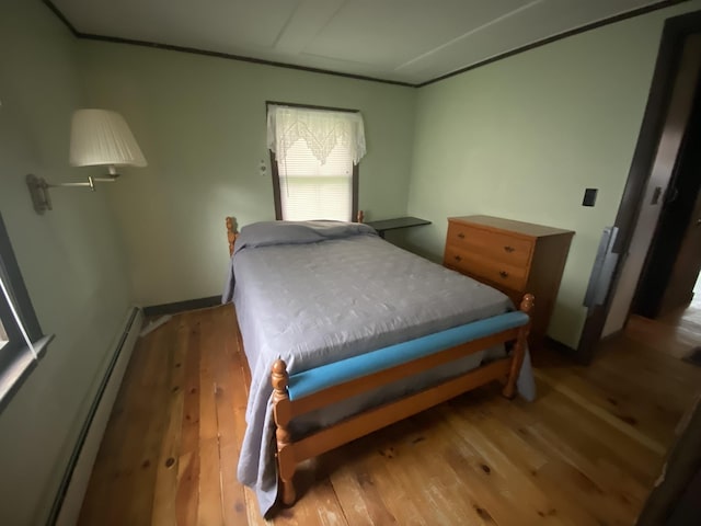 178 Parsons Rd, Wilmington, VT 05363 - bedroom with wood finished floors and a baseboard heating unit