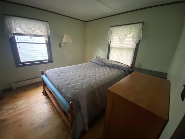 178 Parsons Rd, Wilmington, VT 05363 - bedroom with baseboard heating, multiple windows, hardwood / wood-style floors, and crown molding