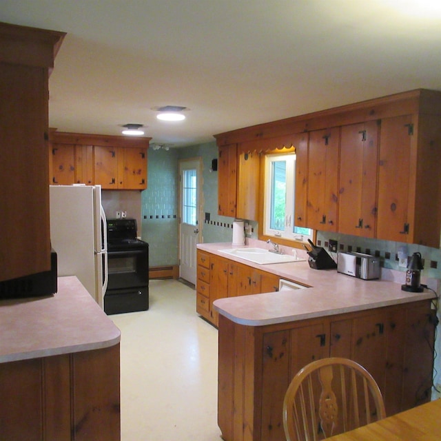 70 Forest Park Dr, Nashua, NH 03060 - kitchen featuring a sink, black electric range, freestanding refrigerator, and light countertops
