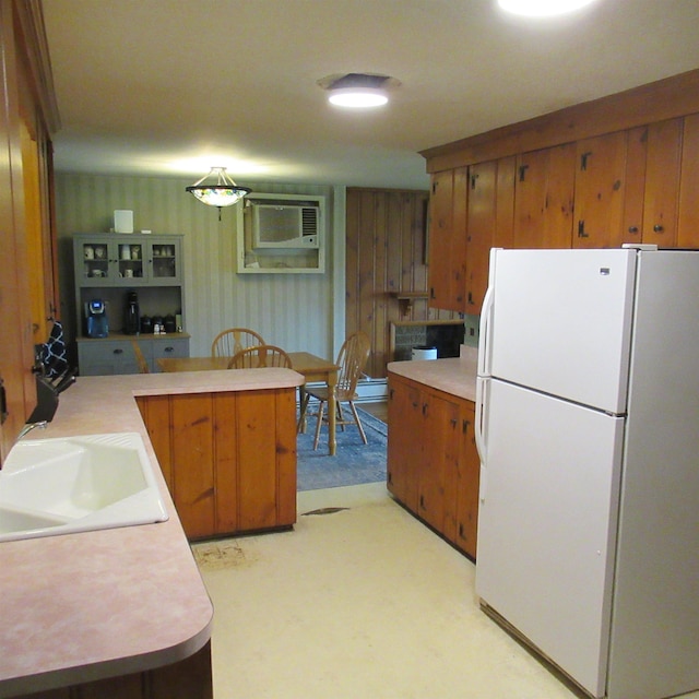 70 Forest Park Dr, Nashua, NH 03060 - kitchen with freestanding refrigerator, brown cabinetry, and light countertops