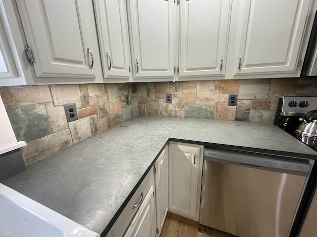 885 N St, Wells, VT 05774 - kitchen featuring stainless steel dishwasher, white cabinetry, decorative backsplash, and light countertops