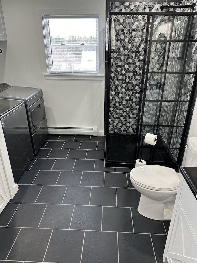 885 N St, Wells, VT 05774 - bathroom featuring washer and clothes dryer, a shower stall, toilet, a baseboard heating unit, and tile patterned flooring