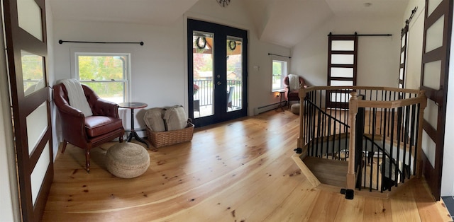 885 N St, Wells, VT 05774 - entryway with a baseboard heating unit, a barn door, wood-type flooring, french doors, and lofted ceiling