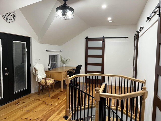 885 N St, Wells, VT 05774 - bedroom featuring a barn door, light wood-type flooring, and vaulted ceiling