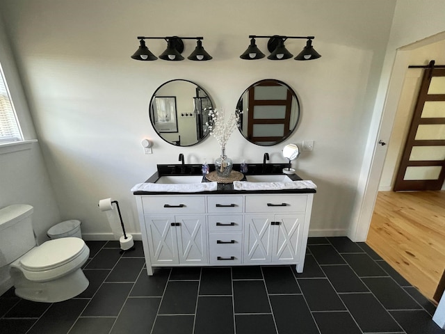 885 N St, Wells, VT 05774 - full bathroom with tile patterned flooring, toilet, double vanity, and baseboards