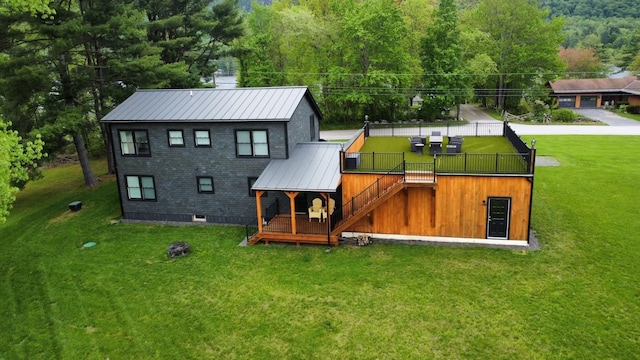 885 N St, Wells, VT 05774 - rear view of property with metal roof, a yard, a wooden deck, and a forest view