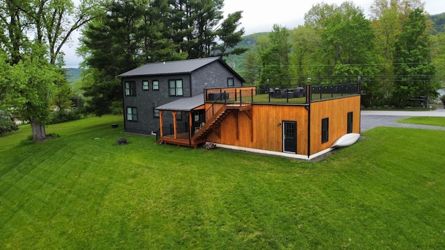 885 N St, Wells, VT 05774 - back of property with metal roof, stairs, a deck, a lawn, and a standing seam roof