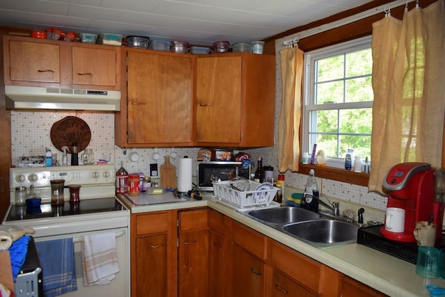 18 Bridge St, Lancaster, NH 03584 - kitchen featuring under cabinet range hood, electric stove, light countertops, tasteful backsplash, and a sink