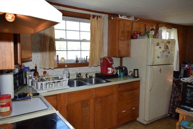 18 Bridge St, Lancaster, NH 03584 - kitchen with a sink, brown cabinetry, light countertops, and freestanding refrigerator