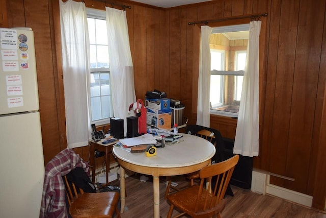 18 Bridge St, Lancaster, NH 03584 - dining room featuring healthy amount of natural light, wood finished floors, and wood walls