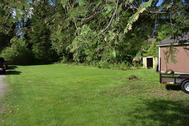 18 Bridge St, Lancaster, NH 03584 - view of grassy yard with an outdoor structure