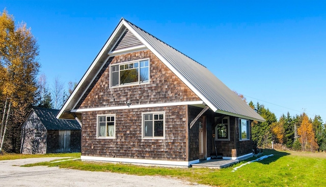 360 Coles Rd, Westmore, VT 05860 - view of front of home featuring a front yard, an outdoor structure, metal roof, and a standing seam roof
