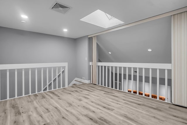 6 Swift Ln, Merrimack, NH 03054 - spare room with a skylight, wood finished floors, and recessed lighting