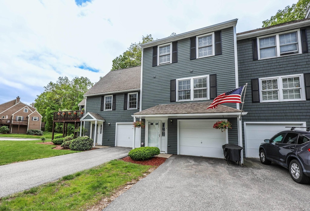 4 Rocky Ledge Rd, Merrimack, NH 03054 - view of front of home featuring driveway, a garage, and a front lawn