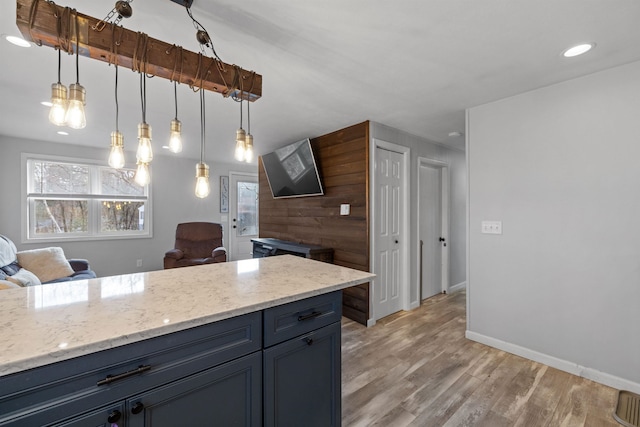 21 Regis Rd, Laconia, NH 03246 - kitchen featuring light wood-style flooring, light stone counters, baseboards, pendant lighting, and recessed lighting