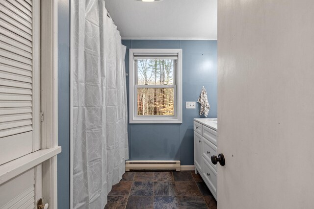 21 Regis Rd, Laconia, NH 03246 - full bath featuring a baseboard heating unit, stone finish flooring, baseboards, vanity, and ornamental molding