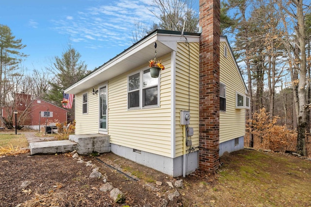 21 Regis Rd, Laconia, NH 03246 - view of side of property with a chimney and crawl space