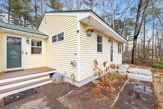 21 Regis Rd, Laconia, NH 03246 - view of home's exterior with metal roof and a deck