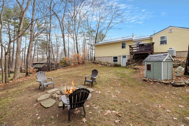 21 Regis Rd, Laconia, NH 03246 - view of grassy yard with a fire pit and a wooden deck