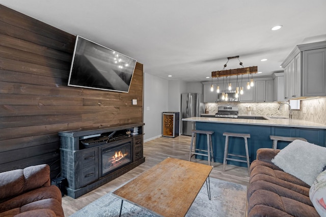 21 Regis Rd, Laconia, NH 03246 - living area with light wood-type flooring, recessed lighting, baseboards, and a glass covered fireplace