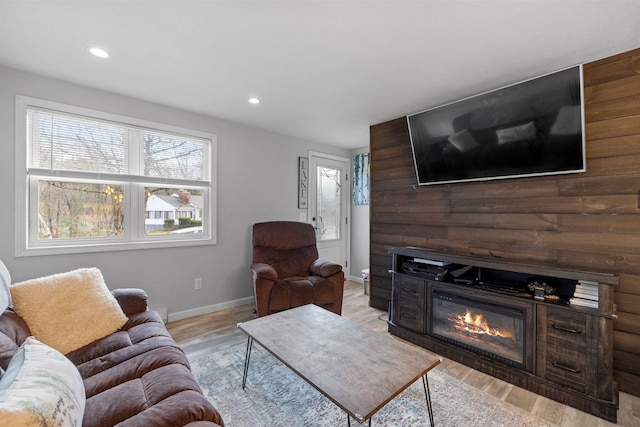21 Regis Rd, Laconia, NH 03246 - living area with baseboards, light wood finished floors, recessed lighting, and a glass covered fireplace