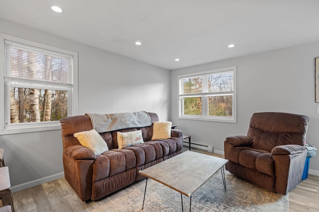 21 Regis Rd, Laconia, NH 03246 - living area with a baseboard heating unit, light wood-type flooring, baseboards, and recessed lighting