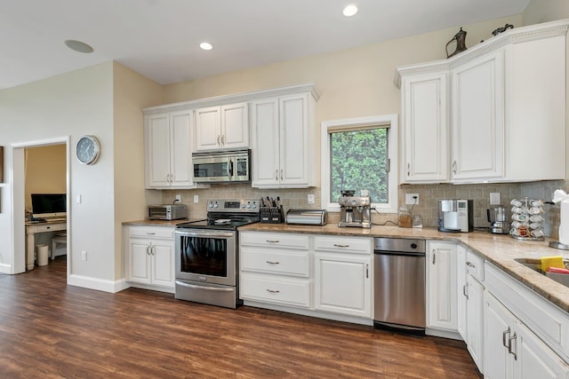 90 Paugus Park Rd, Laconia, NH 03246 - kitchen with appliances with stainless steel finishes, white cabinetry, decorative backsplash, light stone countertops, and dark wood finished floors