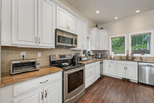 90 Paugus Park Rd, Laconia, NH 03246 - kitchen featuring appliances with stainless steel finishes, a sink, decorative backsplash, white cabinets, and dark wood-style flooring