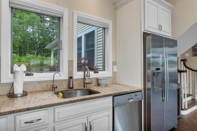 90 Paugus Park Rd, Laconia, NH 03246 - kitchen featuring appliances with stainless steel finishes, a sink, white cabinets, light stone countertops, and backsplash