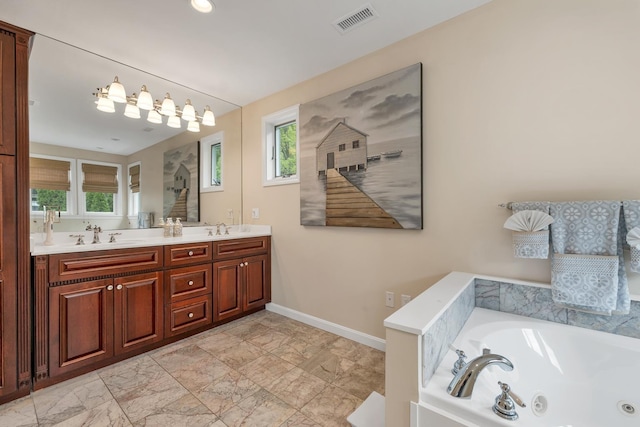 90 Paugus Park Rd, Laconia, NH 03246 - bathroom featuring plenty of natural light, a whirlpool tub, baseboards, and double vanity