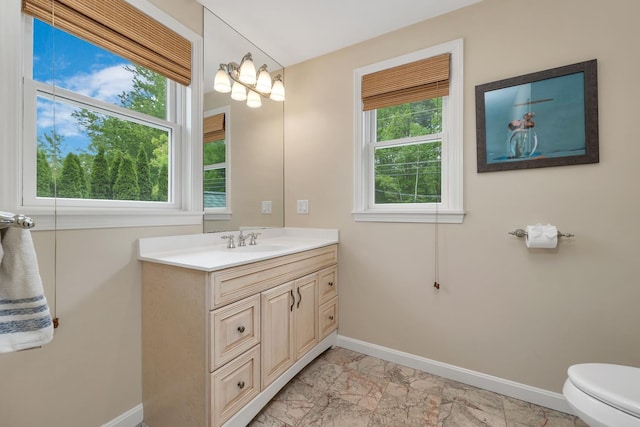 90 Paugus Park Rd, Laconia, NH 03246 - bathroom featuring baseboards, marble finish floors, vanity, and toilet
