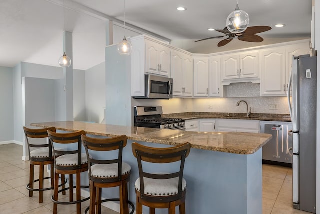 185 Kings Hwy, Hampton, NH 03842 - kitchen featuring stainless steel appliances, a sink, light tile patterned floors, ceiling fan, and white cabinetry