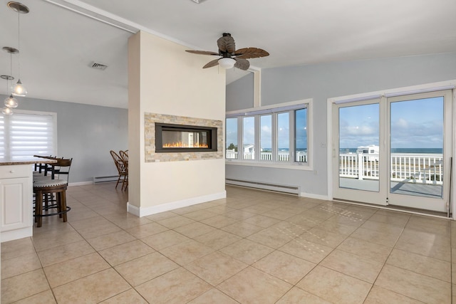 185 Kings Hwy, Hampton, NH 03842 - living room featuring baseboard heating, lofted ceiling, light tile patterned floors, plenty of natural light, and ceiling fan