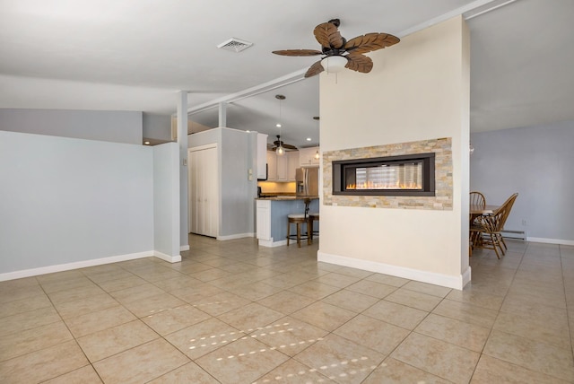 185 Kings Hwy, Hampton, NH 03842 - living area featuring a ceiling fan, light tile patterned floors, a baseboard heating unit, and lofted ceiling