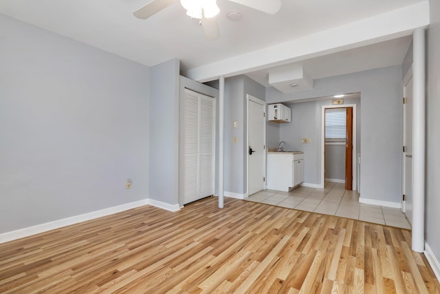 185 Kings Hwy, Hampton, NH 03842 - unfurnished bedroom with light wood finished floors, baseboards, a sink, and ceiling fan