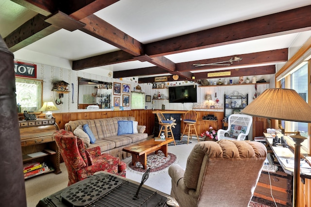 5100 Rte 100, Plymouth, VT 05056 - living room featuring wood walls, beam ceiling, wainscoting, carpet flooring, and ceiling fan