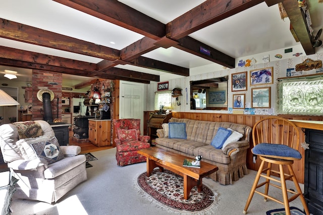 5100 Rte 100, Plymouth, VT 05056 - living room featuring a wood stove, beam ceiling, and carpet flooring