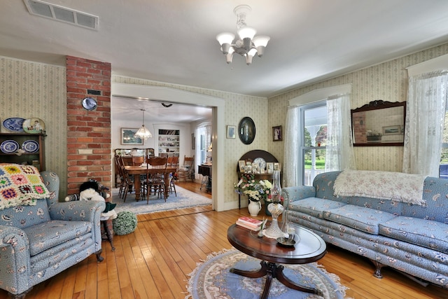 5100 Rte 100, Plymouth, VT 05056 - living room with a chandelier, wallpapered walls, and wood-type flooring